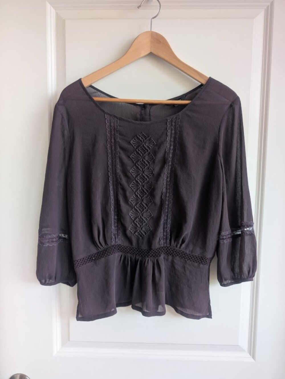 Sheer purple blouse with embroidery detailing.